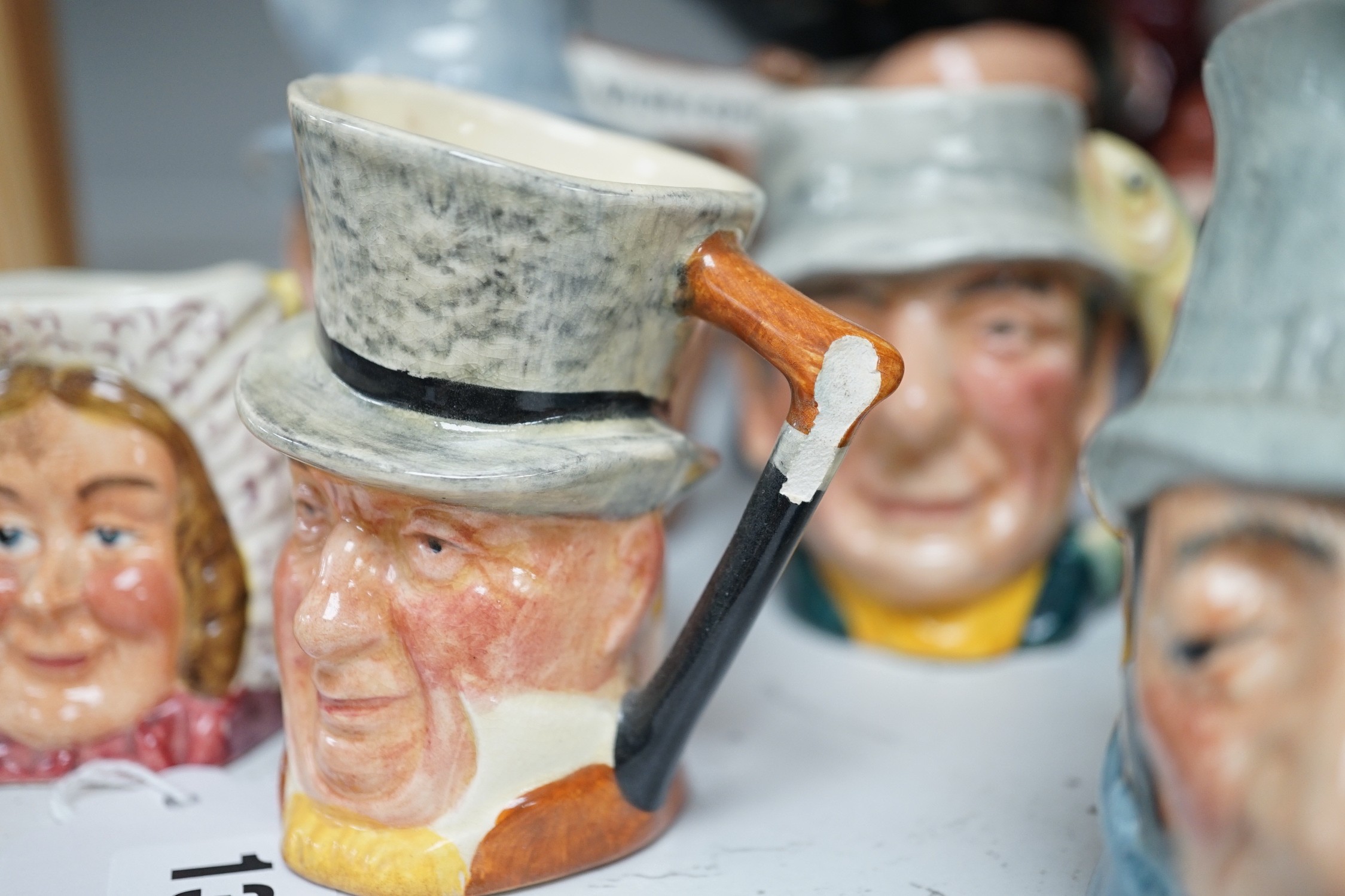 Five Royal Doulton toby jugs and a collection of similar toby jugs